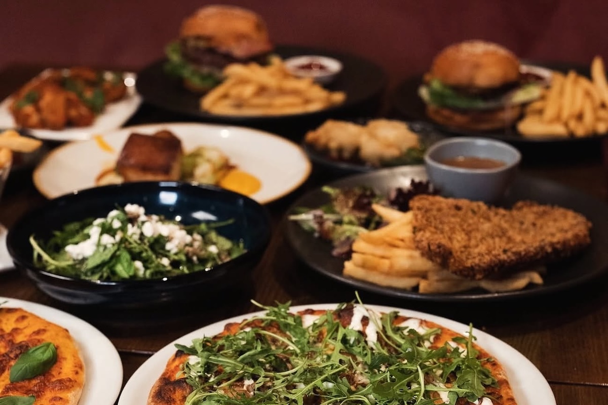 Selection of pub food dishes at the Union Hotel, including pizza, chicken schnitzel with fries, salad, and burgers.